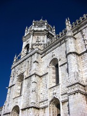 Facade of the Jeronimos Monastery (or Hieronymites Monastery) against the clear blue sky. Lisbon, Portugal, Europe