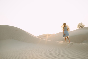 Fototapeta na wymiar Little girl walking in the desert