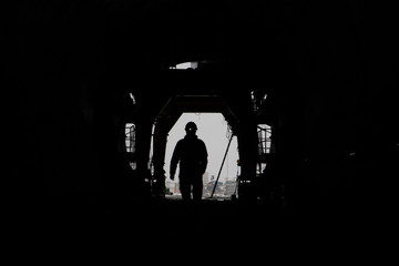 The silhouette of a person in a high-speed railway tunnel under construction