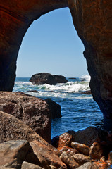 Inside Devil's Punchbowl cave looking out into Pacific Ocean waves