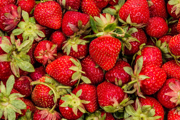 just fresh red strawberries with green leaves