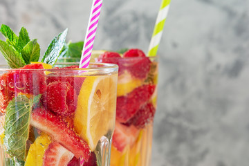 Bubbles Freshness Fruit Drink Closeup Side View. Green Mint Leaves, Breezy Ripe Berries and Citrus...