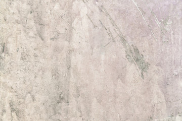 Old plastered wall with stains and scratches. Light beige putty. Decorative coating with an uneven texture. Blank background for layouts.