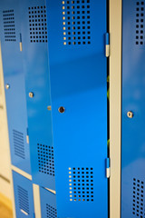 Blue work cabinets ajar with ventilation openings.