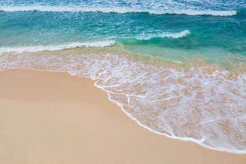 Fototapeta na wymiar The turquoise sea lapping a sandy beach, on the Caribbean island of Barbados