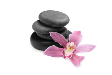 Fototapeta na wymiar Beautiful orchid flower and spa stones on white background