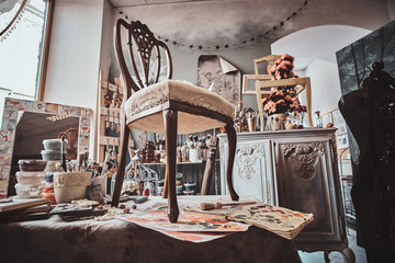 Photo of artist's pretty soiled workshop with chair ready for restouration on the table.