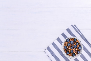 Muesli with blueberries on a white background. Free space for text. Copy space.