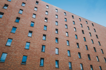 windows on brick building facade of apartment block