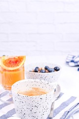 Traditional european breakfast on white wooden background. Muesli with berries and orange juice.