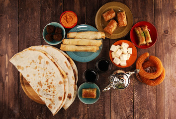 Middle eastern or arabic dishes and assorted meze, concrete rustic background. Turkish Bread or...