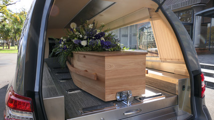 closeup shot of a funeral casket in a hearse or chapel or burial at cemetery - obrazy, fototapety, plakaty