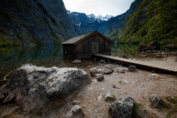 Boat dock hangar on Obersee mountain lake in Alps. Bavaria, Germany