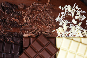chocolate in diffrent color. milk, dark and white chocolate bars on table