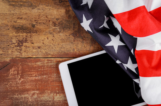 Technology, patriotism, anniversary, national holidays of tablet on american flag and independence day - Powered by Adobe
