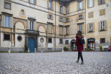 Young woman walking by Bologna centre