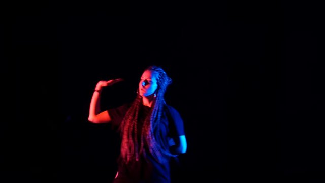 girl with african braids dancing hip hop,street dance in the studio,isolated