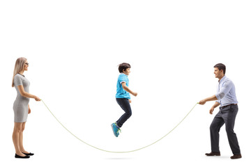 Mother and father holding a rope and a boy skipping