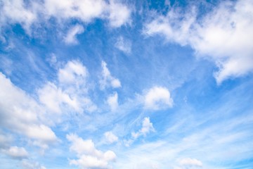 Beautiful white fluffy and cirrocumulus clouds on a blue sky background