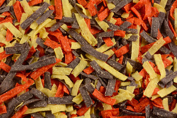 Background close up of tricolor yellow red and purple corn tortilla strips as ingredient or soup...