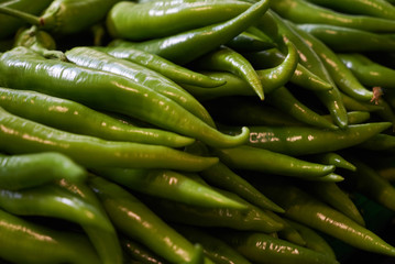 Fresh green chili peppers background, close-up. Hot