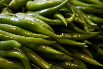 Fresh green chili peppers background, close-up. Hot