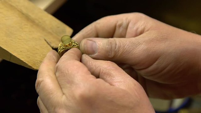 jeweler in the workshop increases the size of the ring