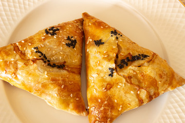 Samosa on a white plate. yellow samosa on a white plate. yellow Samos emoticon