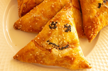 Samosa on a white plate. yellow samosa on a white plate. yellow Samos emoticon