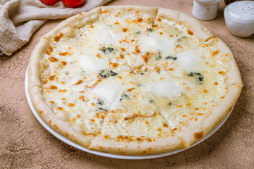 Pizza Quattro formaggi on white plate