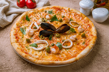 Pizza with seafood on rustic table