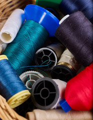 Coil Threads in mess sewing supplies close up.