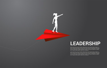 silhouette of businesswoman standing on red origami paper airplane. Business Concept of leadership, start business and entrepreneur