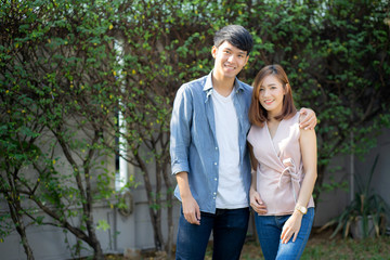 Fototapeta premium Beautiful portrait couple looking each others eyes and smiling with happy, young asian man and woman relation with love dating, husband and wife feeling and emotion, lovers and lifestyle concept.