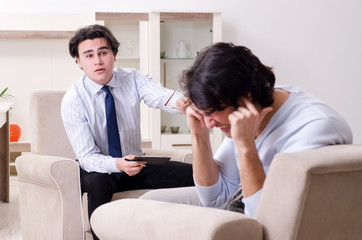 Young male patient discussing with psychologist personal problem