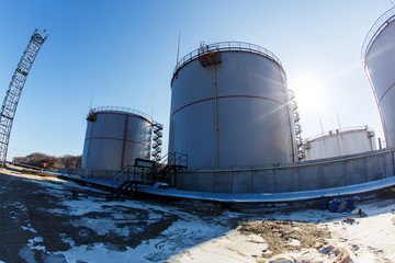 Large silver tanks for the storage of petroleum products in the open. Oil storage.