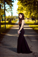 Beautiful young lady in luxury black dress is ready for her prom night