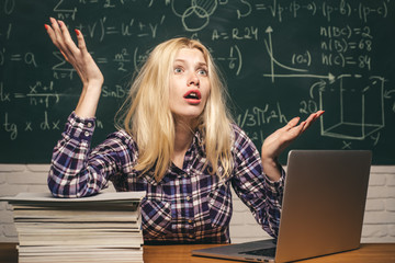 Back to school. Tired student learning at home. Knowledge day. Education and campus people concept. Girl stressed by studying to hard screaming classroom background.