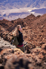 Fototapeta na wymiar Young woman hiking the Teide Volcano in Tenerife, Canary Islands, Spain