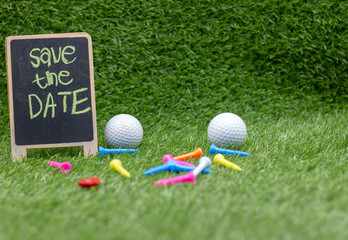 Naklejka premium Golf Save the date with golf balls and tee on green grass
