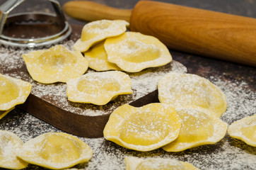 Uncooked fresh homemade tomato and mozzarella ravioli. Italian cuisine - raw ravioli, made of flour and egg