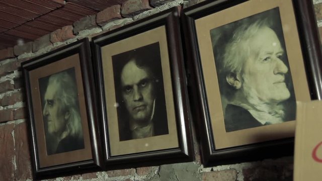 Portraits of Famous Composers on an Old Wall in a Piano Workshop - Close Up