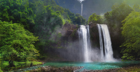 Twin Waterfall Rain Forest In Valley Like A Paradise Garden With Turquoise Green Pond and Blur Waterfall  Mountain Behind. Curug Sodong Amidst Tropical Rain Forest in Global Geopark Ciletuh