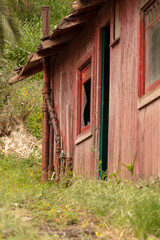 Old abandoned building falling apart with broken windows and doors