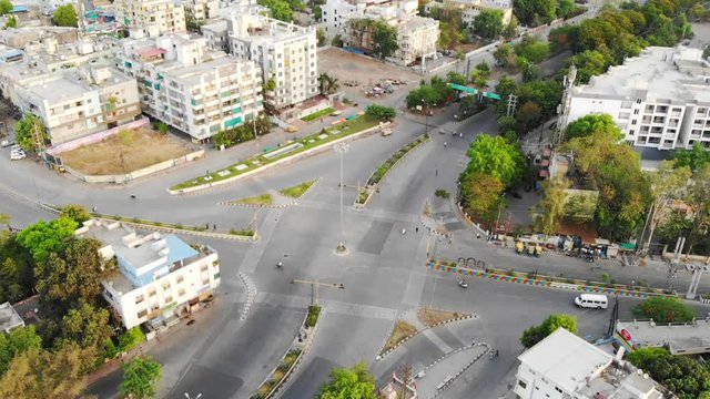 aerial view of traffic on a square junction early morning with people and traffic