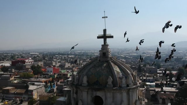 Drone aerial view of some baroque church dome and birds