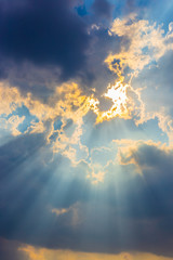 The sun light passes through the clouds after rain. © Rattapol