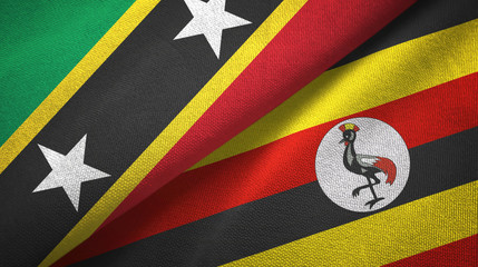 Saint Kitts and Nevis and Uganda two flags textile cloth, fabric texture