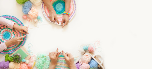Master class on knitting. Women crochet and knit from colored yarn.