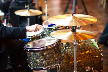 A drummer playing a small drum set.